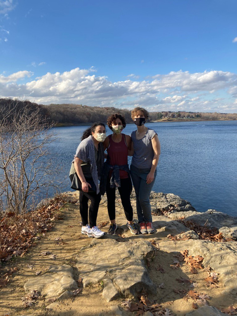 group of fellows posing in front of a body of water