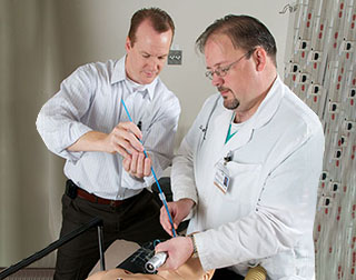 Fellow and faculty performing intubation simulation