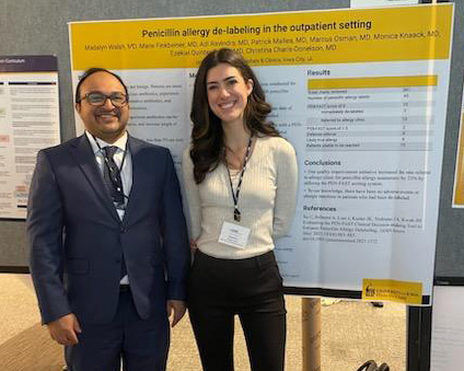 Residents in front of their research poster at the 2023 SGIM meeting