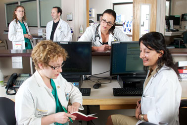 Residents near nursing station talking with other staff