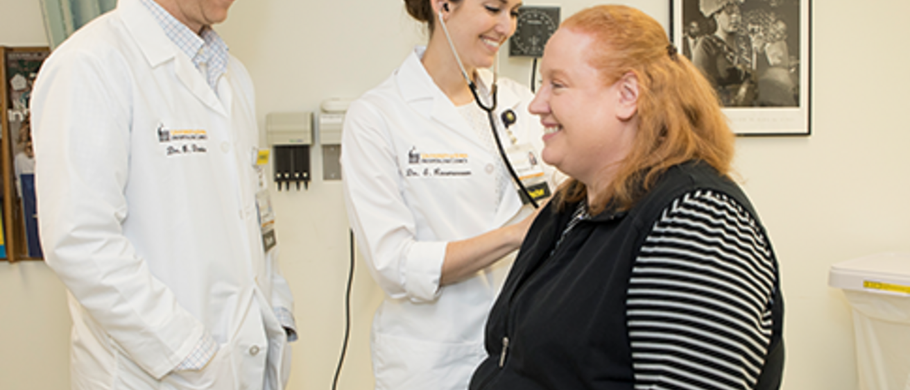 physicians examining a patient in clinic