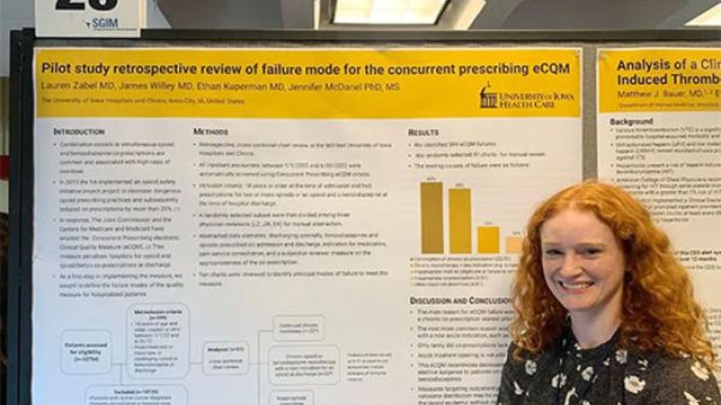 Photo of a resident presenting a QI poster
