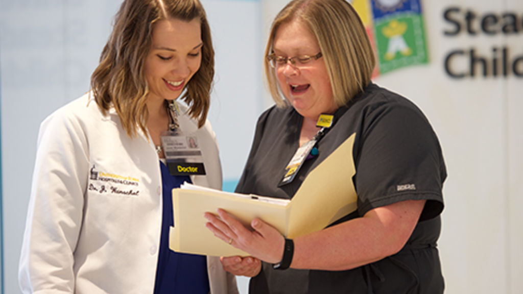 mentor and trainee reviewing a file
