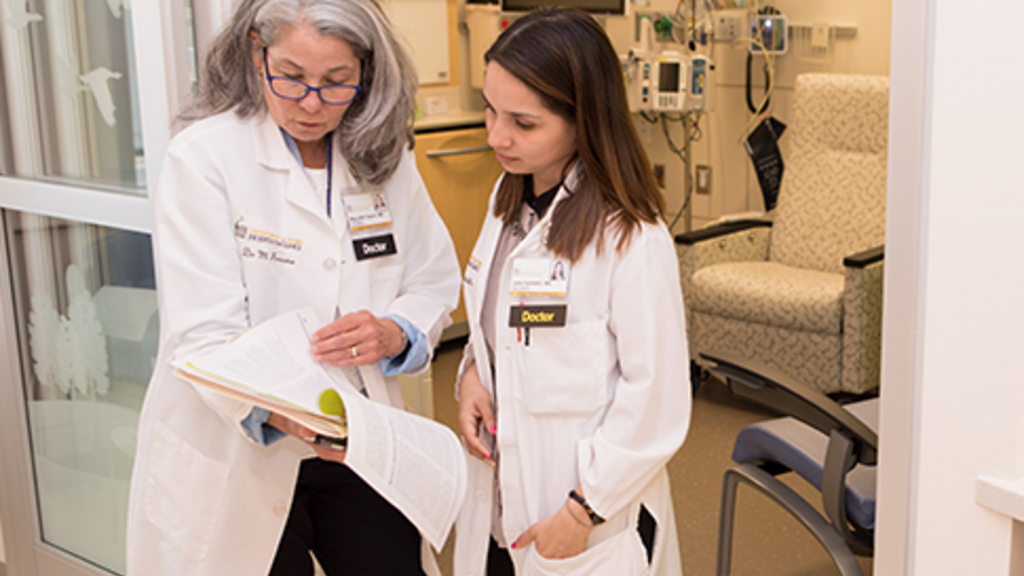 mentor and trainee reviewing a consult